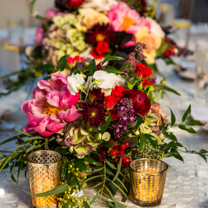 Gorgeous Jewel Toned Centerpieces and Gold Candle Holders featured in this Whimsical Vegas Wedding