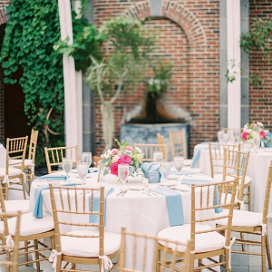 Outdoor wedding reception with hot pink floral centerpieces