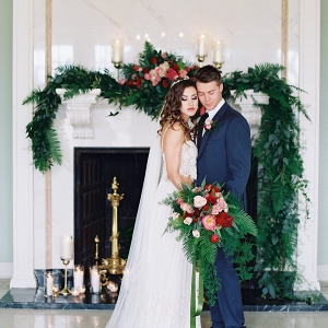 Bride and Groom in front of Greenery Mantel