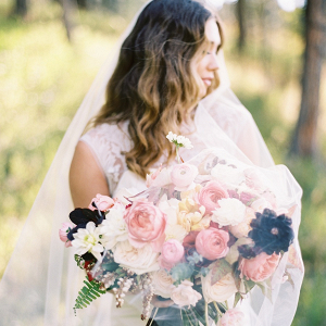 Bride with pink and black bouquet