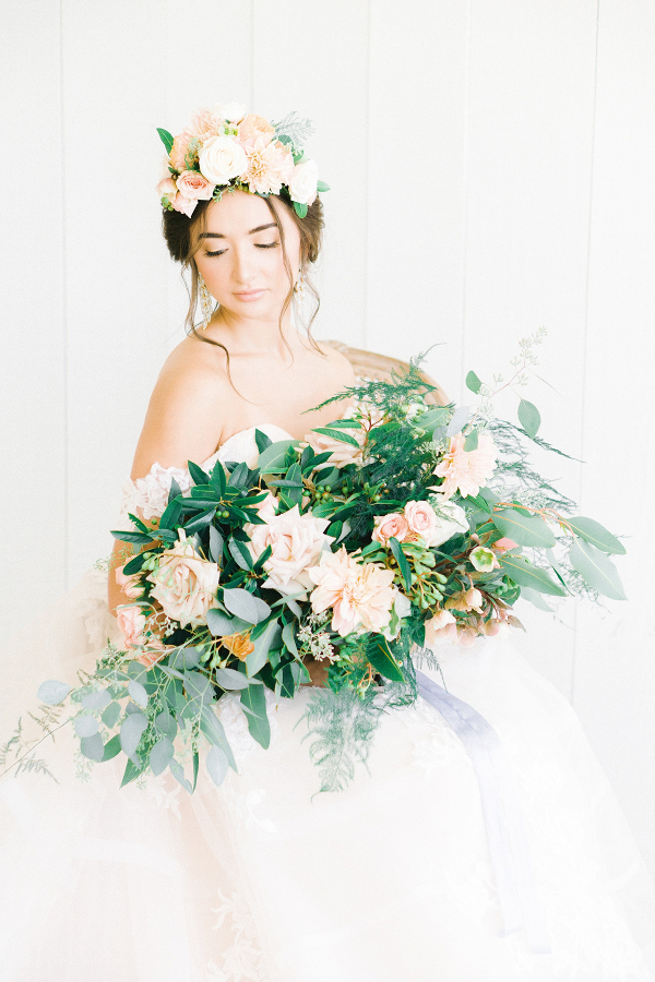 Bride with oversized peach and greenery bouquet and floral crown