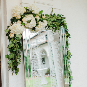Mirror seating chart with draped florals