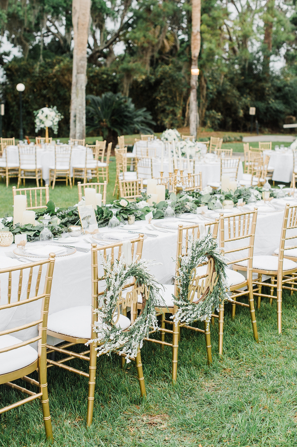 Outdoor reception with greenery table runners