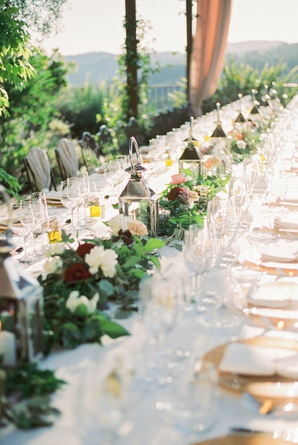 Long wedding table with garland and lanterns