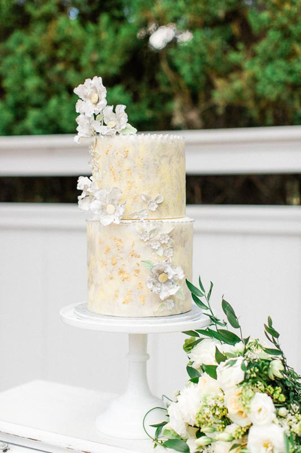 Light yellow wedding cake with sugar flowers