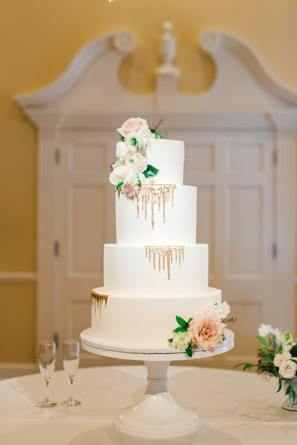 Classic white wedding cake with gold drips