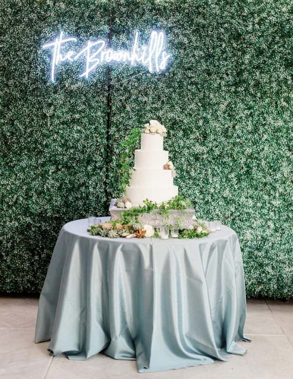 White cake table with custom neon sign