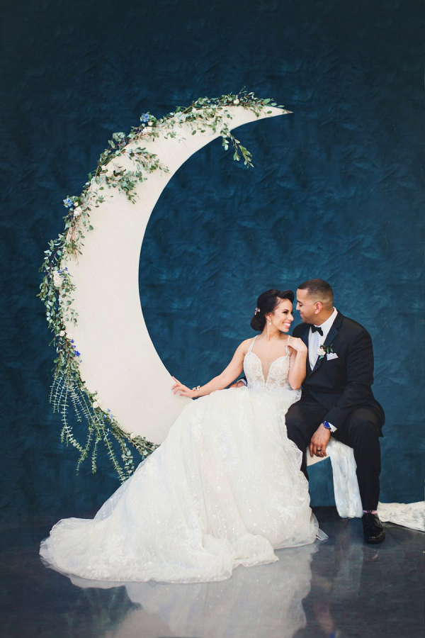 Bride and groom on moon backdrop