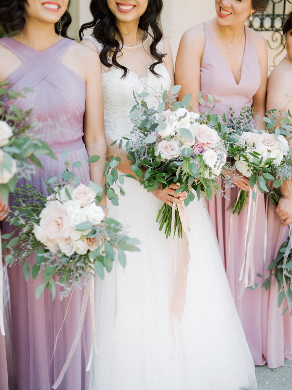 Bridesmaids in mismatched blush and lavender dresses