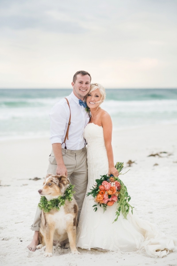 Bride and groom portrait on the beach with their dog