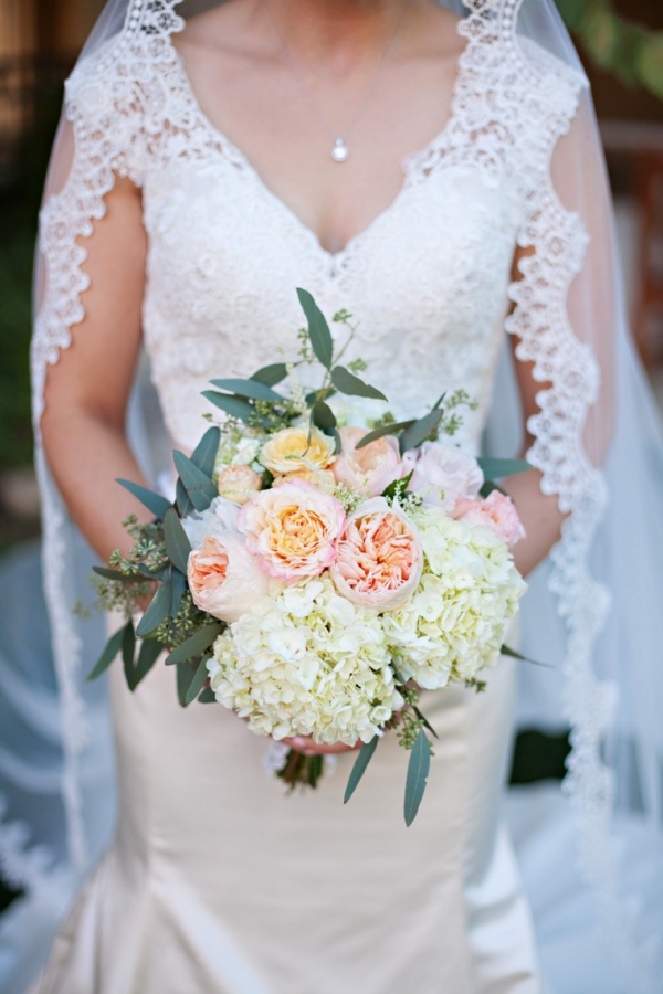 White and blush bouquet with a lace veil