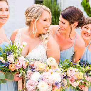 Blue bridesmaids with pastel bouquets