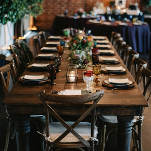 Colorful farm table wedding reception with wood box centerpieces