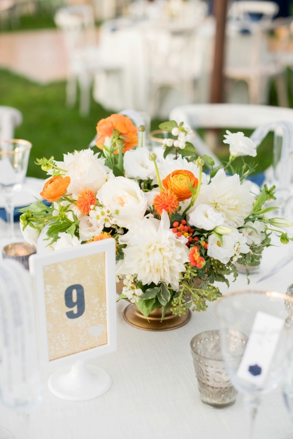 Eclectic orange and white centerpiece with simple table number