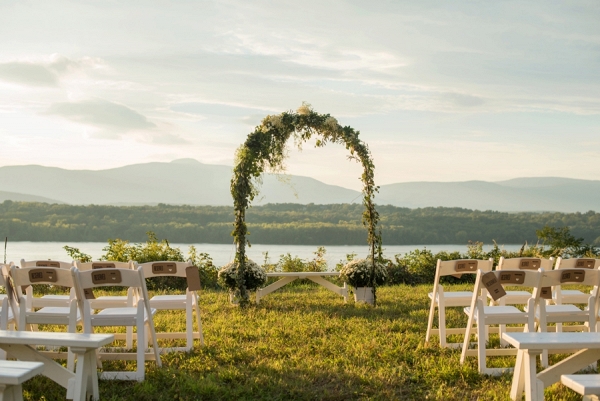 Outdoor ceremony arch adorned with flowers and greenery