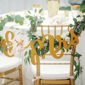 Mr & Mrs Chair signs with greenery 