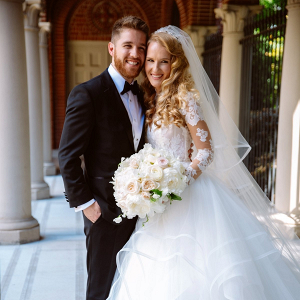 Classic bride in long sleeve lace and tulle gown with groom