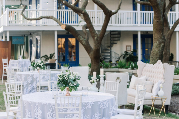 Outdoor wedding reception with lace linen overlays