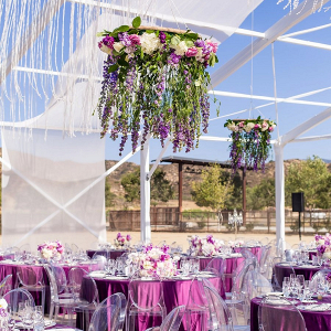 Open tent wedding reception with floral chandeliers 