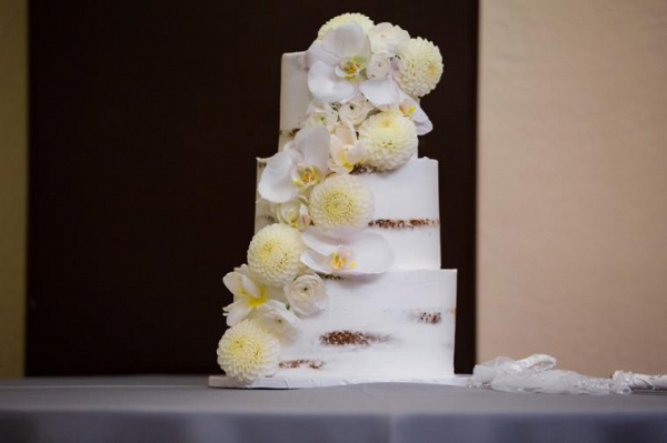 White semi naked cake with fresh orchids