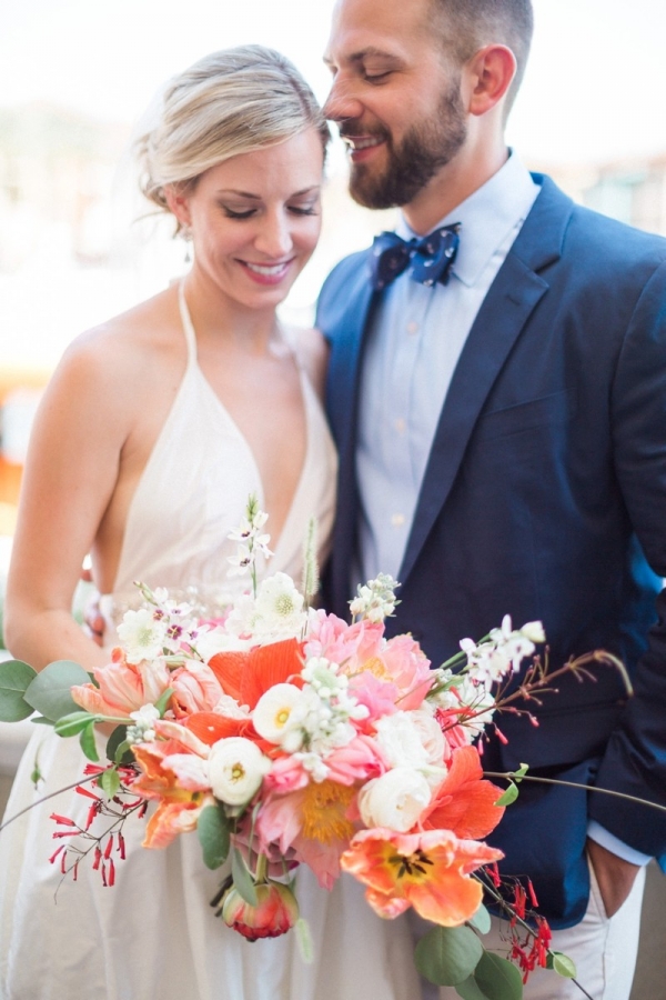 Bride and groom with coral bouquet