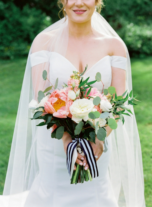 Peach bridal bouquet with navy and white stripe ribbon