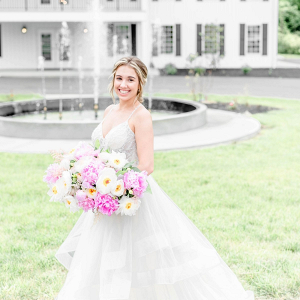 Bride with lush pink and white peony bouquet