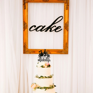 White wedding cake with silhouette topper