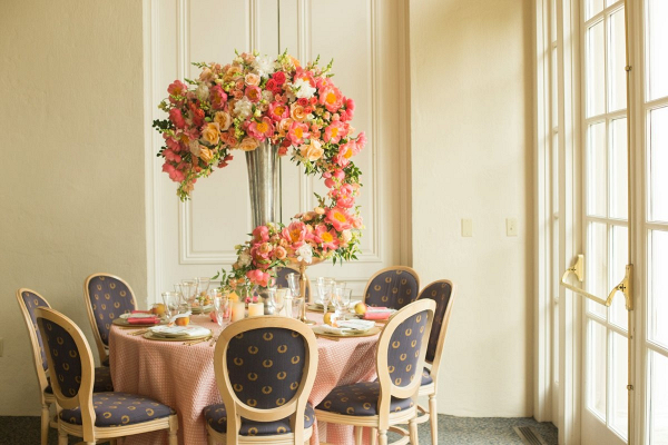 Tall orange floral centerpiece with trailing florals