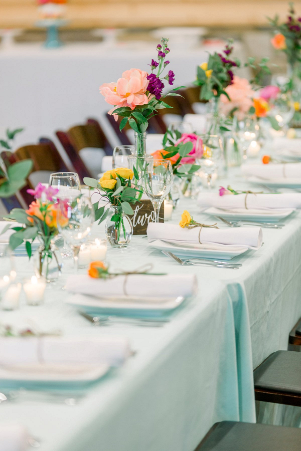 Colorful wedding tablescape with bud vases
