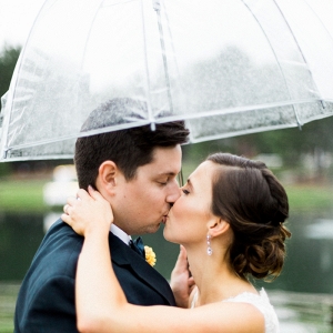 Bride and groom with an umbrella