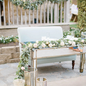 Sweetheart table with mirror table and floral garland