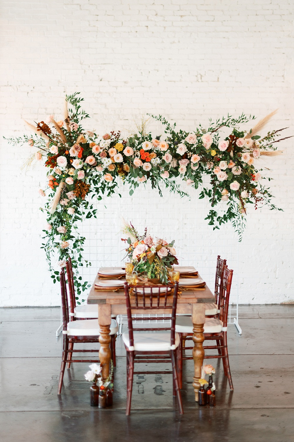 Retro wedding table design with hanging floral installation 