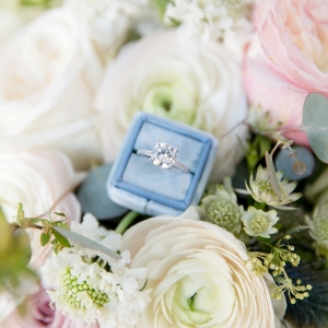 Blue ring box with a solitaire diamond ring