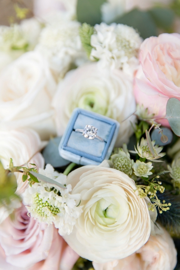 Blue ring box with a solitaire diamond ring