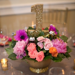 Pink and orange centerpiece with glitter table number