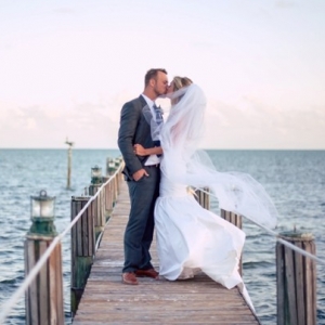 Bride and groom portrait on a dock