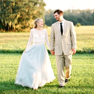 Bride in a pale blue tulle skirt and groom in a tan suit