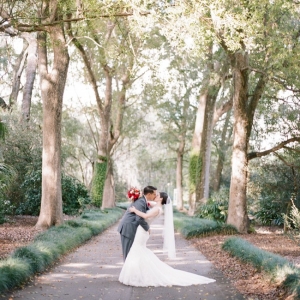 Bride and groom kissing under Spanish Moss 