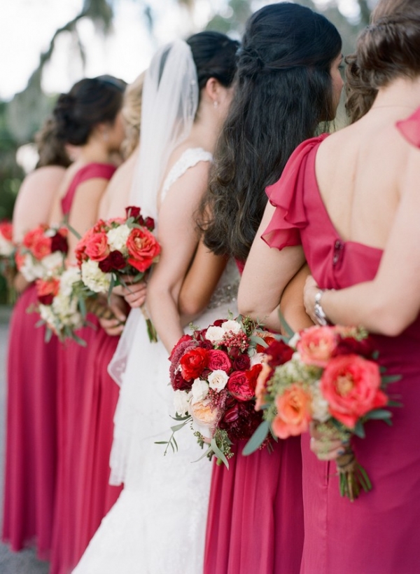 Bride and bridesmaids with red and white flowers