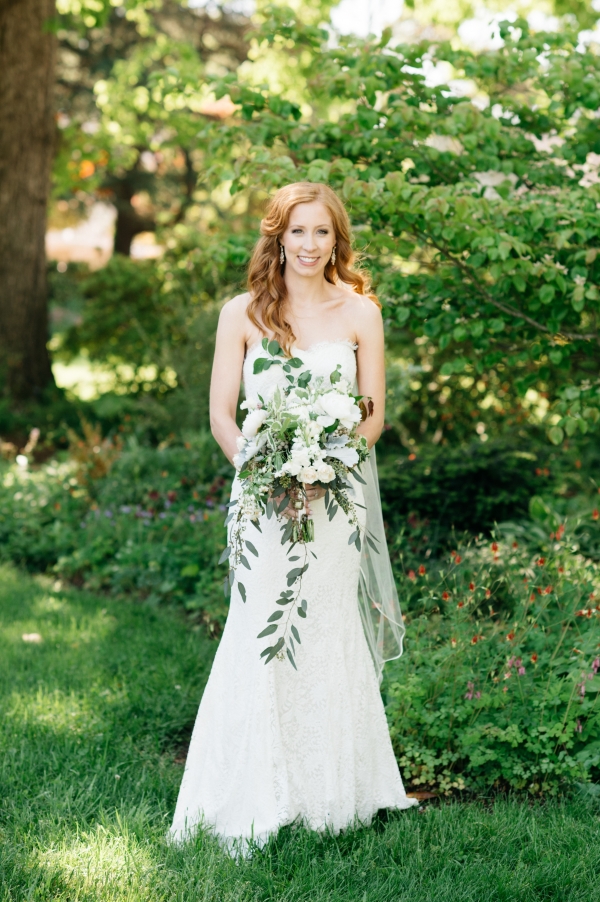 Bride with green and white cascading bouquet 