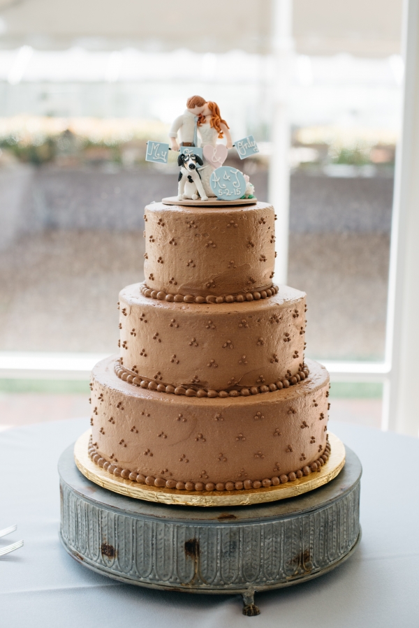 Gold wedding cake with bride, groom and dog topper