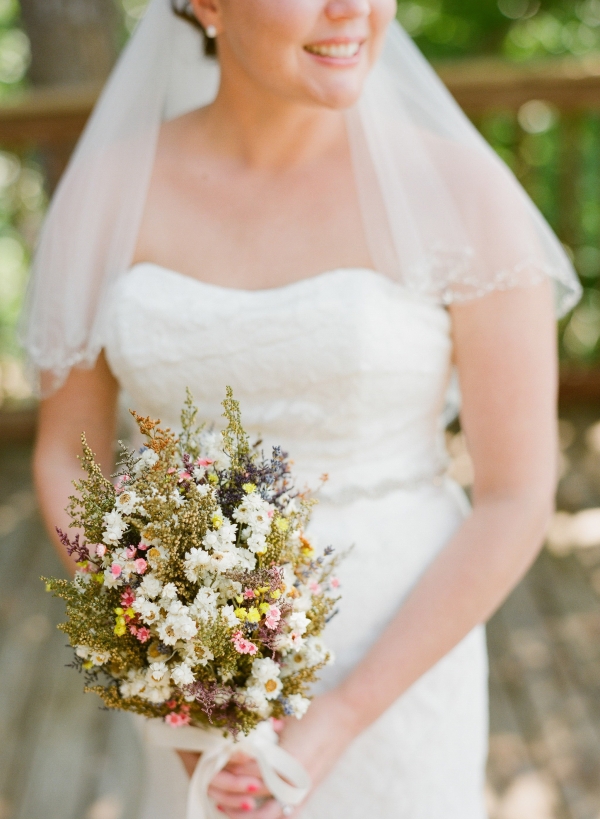 Bride holding dried flowers