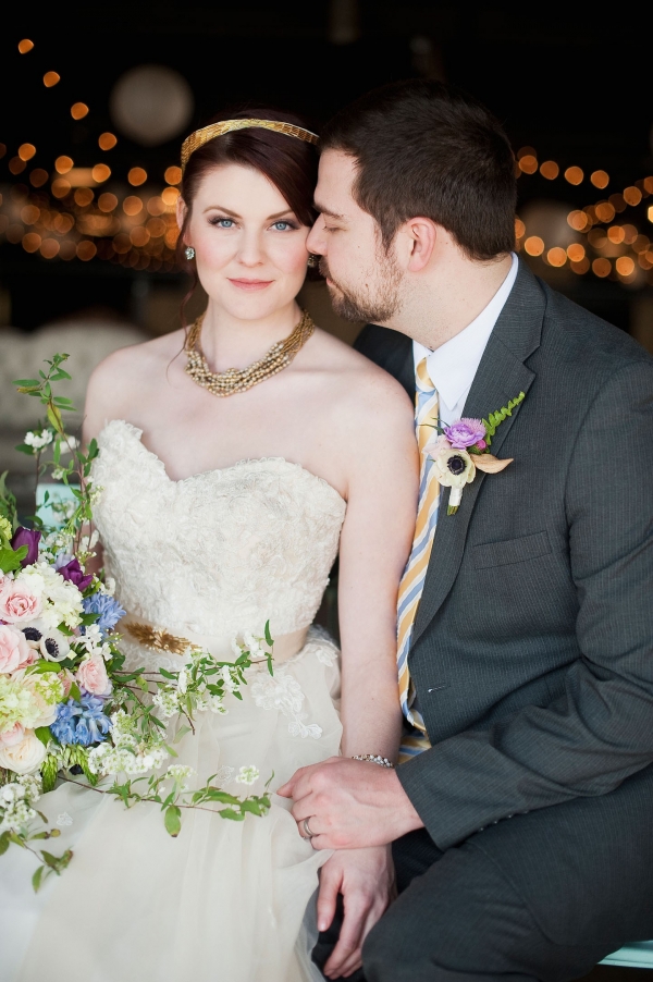 Bride with gold accessories and groom in gray suit
