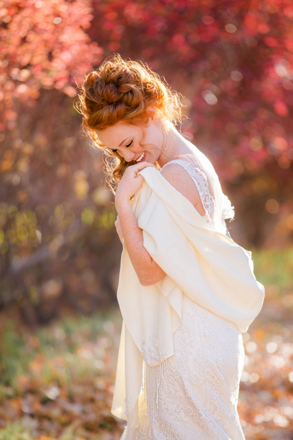 Bride In Front Of Fall Foliage With Sunlight Behind