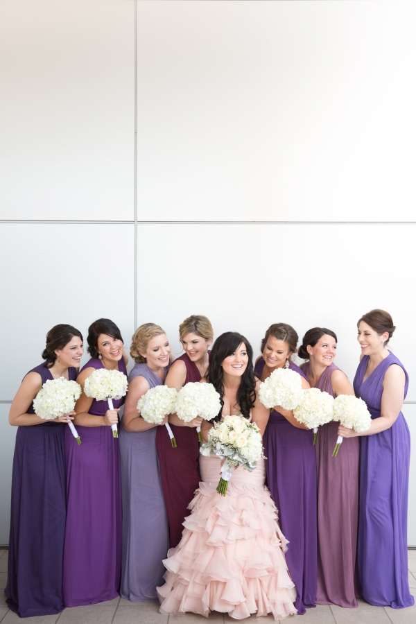 Bridesmaids in different shades of purple with bride in blush 