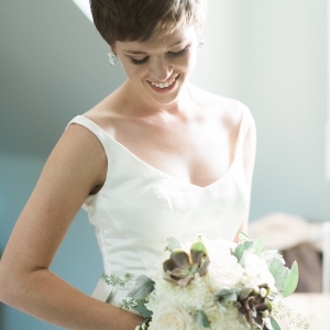 Romantic bride with white and green bouquet  