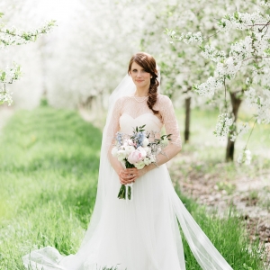 Bride in cherry tree orchard