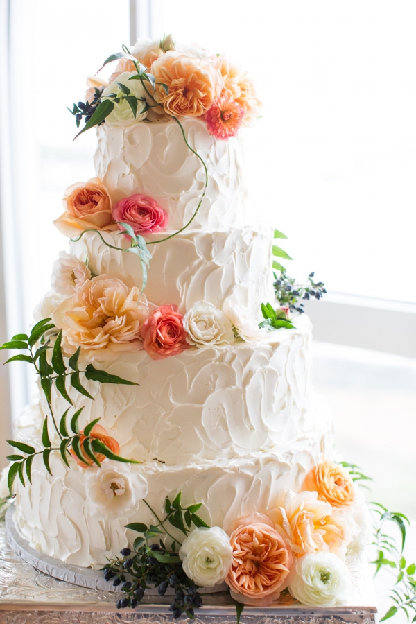 Buttercream cake with peach, orange and ivory flowers
