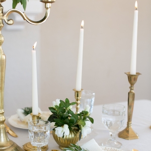 Gold candlesticks, gold flatware and gold decor plates